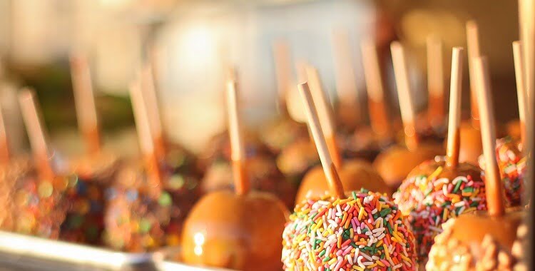 Person grabbing street food on sticks