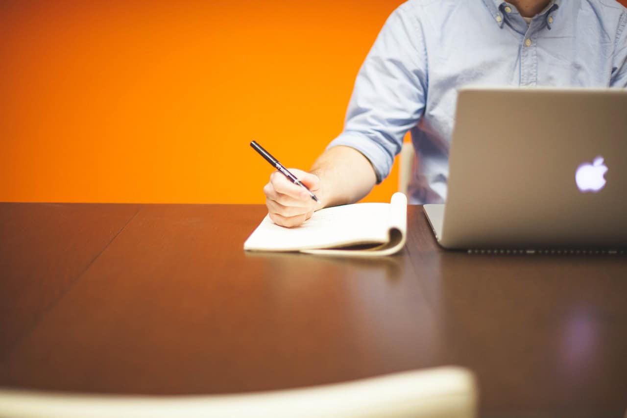 Modern workspace with laptop and notepad for productivity at Brixx.
