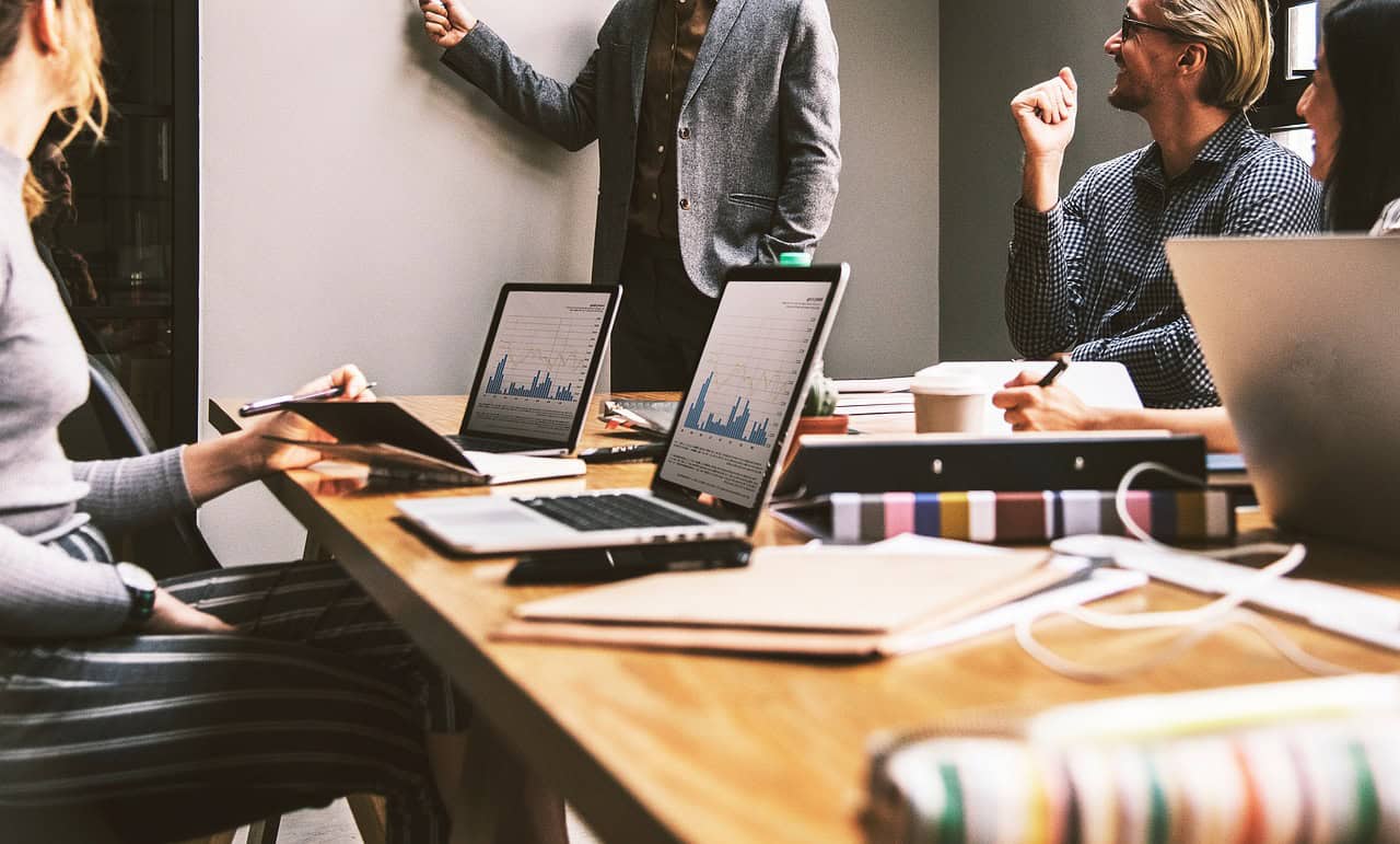 Business team discussing strategies during a meeting in a contemporary office environment.