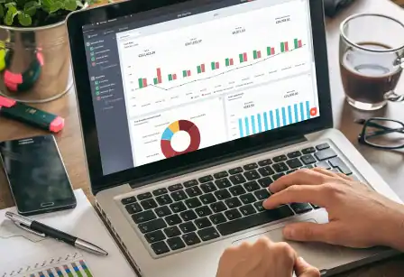 Business analytics dashboard showing sales and revenue data on a laptop screen.