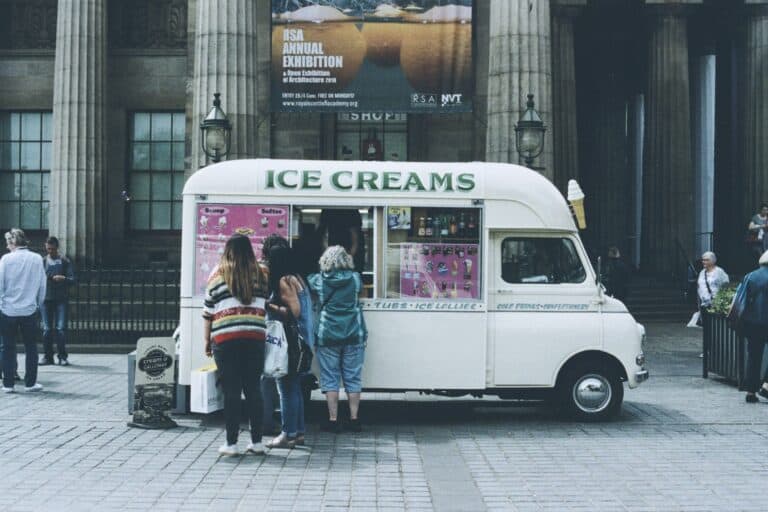 Ice Cream Van serving delicious treats in a busy city square, attracting families and tourists. Perf.