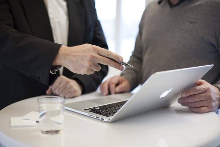Business professionals discussing on a laptop during a meeting at Brixx.